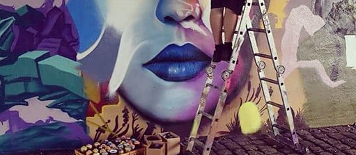 Justus Becker painting a mural