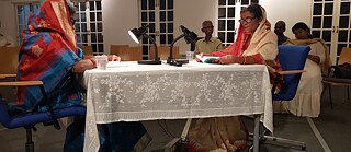 Indian artist Paribartana's mother Bishnupriya Mohanty (left) and aunt Sarojini Mohanty (right) reading from Rupantara, the Oriya translation of The Metamorphosis by famous Indian writer Kamalakanta Mahapatra as part of his artistic project, Five Million Incidents, at the Goethe Institut, New Delhi