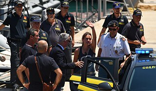 Violation of Italian law, but not international law: the captain of Sea Watch 3, Carola Rackete, with Italian police officers after her arrival in Lampedusa.  