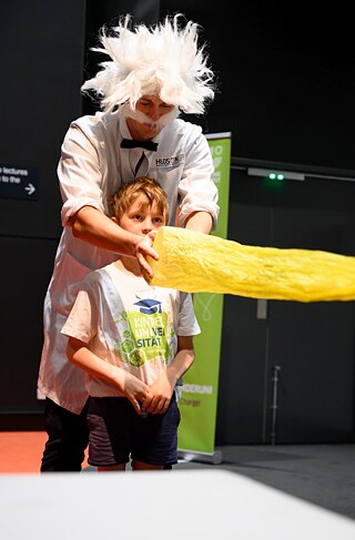 "Professor Einstein" gets some help from a student during the live science show