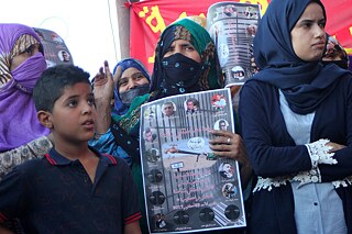 A group a people on the street, protesting.