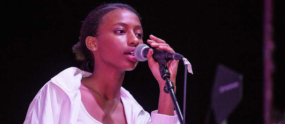 One of the female artists performing on stage. 
