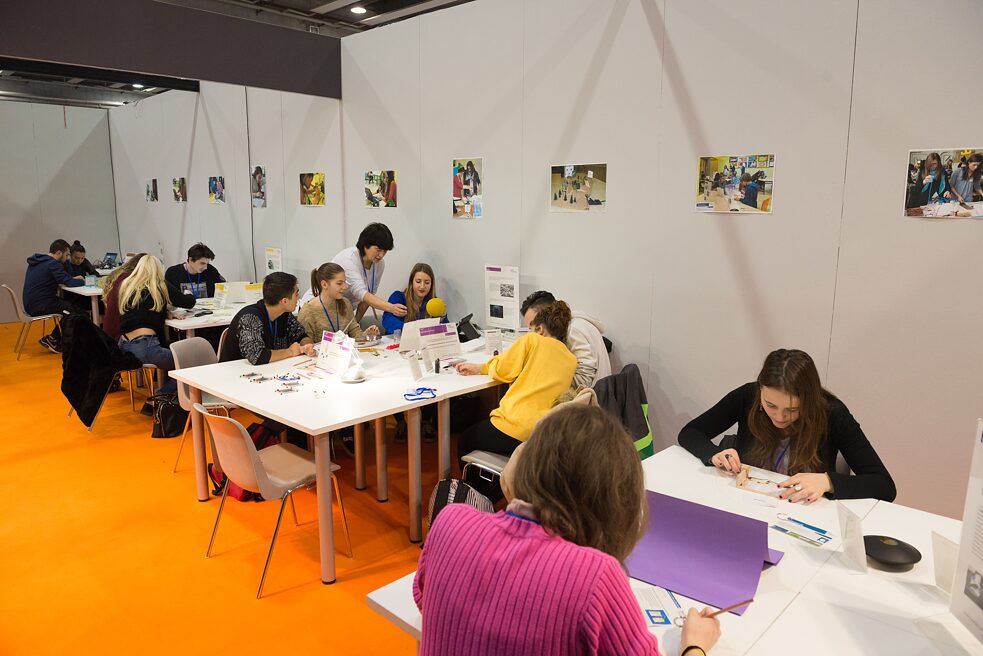 Die Tutorin hilft den Schülerinnen und Schülern, wenn sie Schwierigkeiten haben.