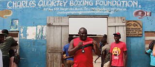 Scene in front of the Charles Quartey Boxing Foundation from the film “Lionhearted” 