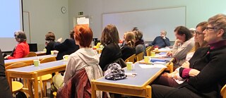  Die Teilnehmenden lauschen einen Vortrag über Wirtschaftsbeziehungen in Europa