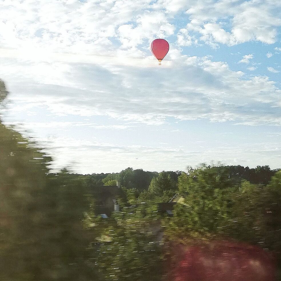 Der Blick aus dem Fenster des RER auf die vorbeiziehende Landschaft 