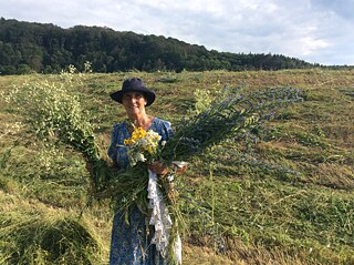 Mrs Pohl picking flowers from their fields