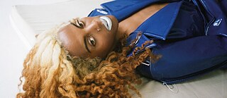 Juliana Huxtable lying on the floor