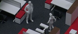 Modell mit zwei weißen Menschenfiguren in einer Bürolandschaft