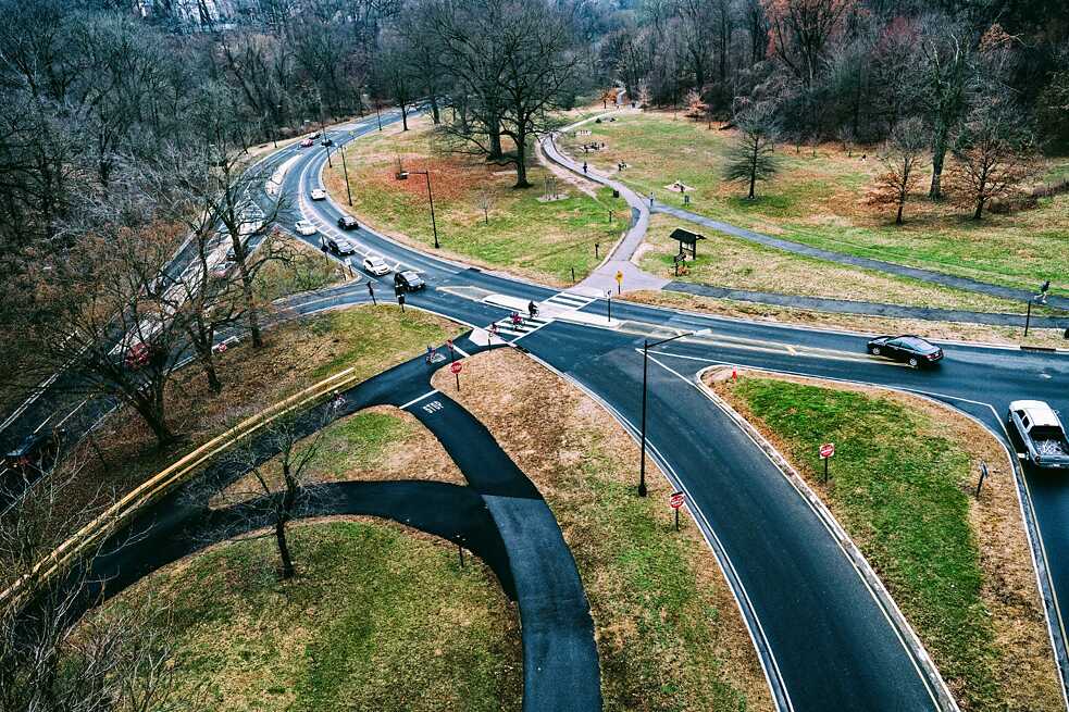 Adding roads and bike paths to a growing a city can create stressful intersections. Sometimes, though, the result is a work of art – an abstract asphalt sculpture laid over the landscape. This one in Rock Creek Park is seen from DC’s Taft Bridge.