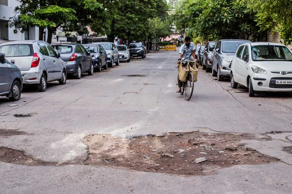 This young man arrives on the bike to repair the broken asphalt on the road. In handicrafts, patchwork can be used as a creative way to repair old textiles. But is this really the ideal solution for roads?