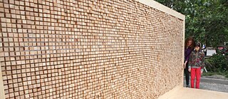 „Desaparece el muro“ es una instalación que consiste en una estructura de metacrilato que se rellena con aprox. 6.000 bloques de madera.