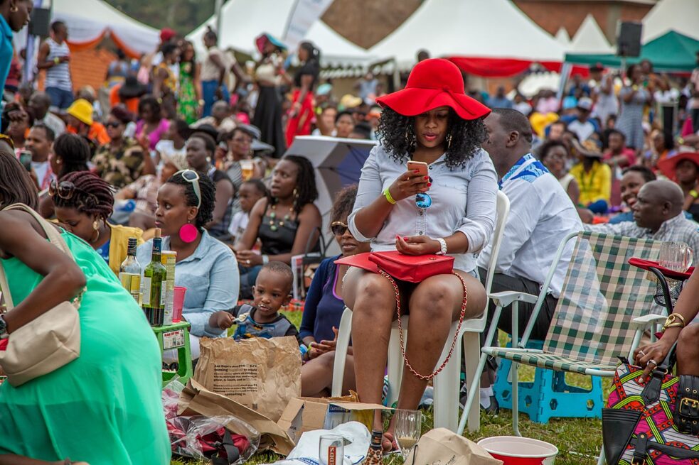 A woman looks at her phone at an event at Uganda National Museum in Kampala