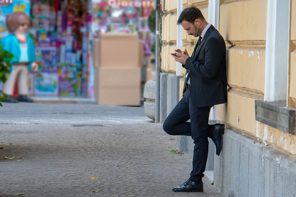 A man in a suit listens to music