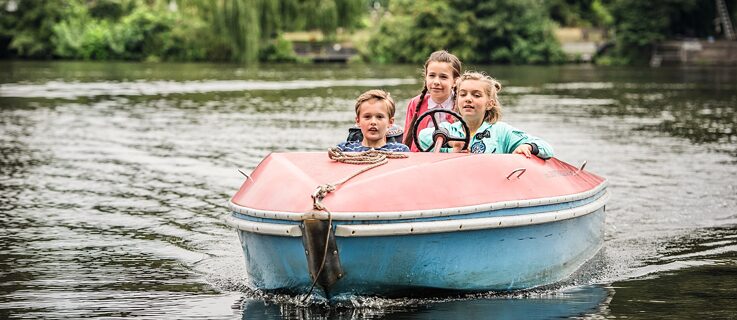 Rocca and two friends are driving a boat