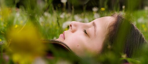 a girl sleeps in a meadow