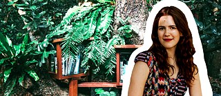 Blanca, Promovendin der Mathematik, vor einem grünen Hintergrund aus Blättern und Büchern