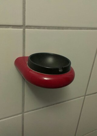 An ash tray inside a toilet cubicle at Tegel Airport