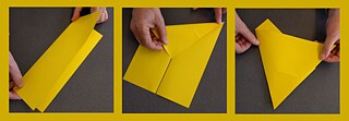 DIN A4 formato geltonas lapas popieriaus lankstomas kol įgauna trikampio formą.