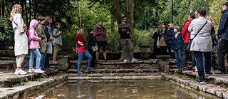 Viele Mensche um den Teich © © Katarina Zlatec Die Pumpe und die Uhr