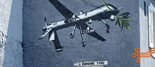 A graffiti of a war drone with a palm leaf in Geneva.