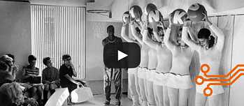 A group of models in boots perform short mini dresses with transparent tops during a fashion show by designer André Courrèges.