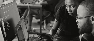 Man being assisted on computer 