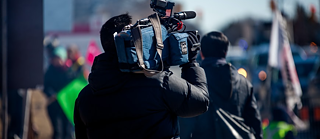 Man carrying a professional camera 