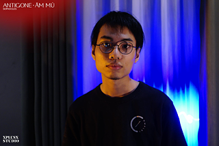 Nguyễn Quang Kiếm (*1995) | Project and Stage Manager / Concept writer of the Interactive script<br><br>Nguyễn Quang Kiếm had backgrounds in Marketing, Film Directing, and Literature. A Hanoi-based art & cultural organizer, a community builder, and a creative at Long Year in Theatre since its foundation. In Antigone - Âm Mù, he wrote the concept, researched, interpreted and consulted with the creative team on the interactive script, recruited and managed the production crew.