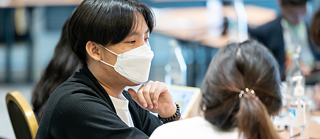 Two people at a table talking