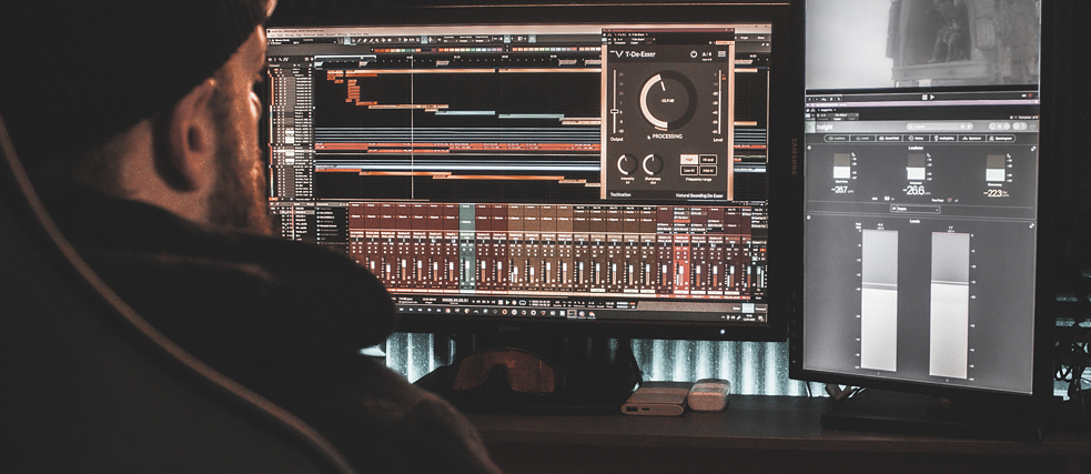 Man sitting in front of screens