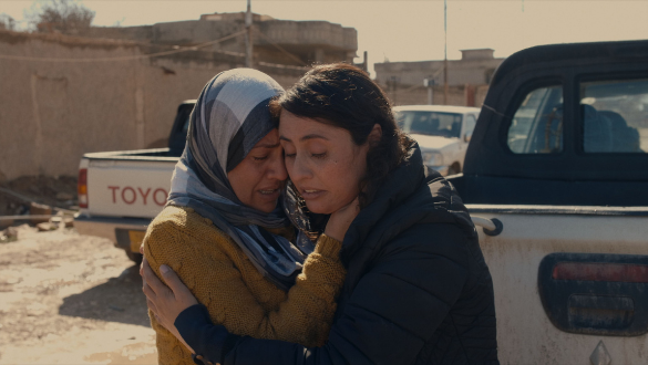 Doc Edge Festival 2022. Image from the film "Angels of Sinjar" in which two women are embracing and consoling each other.