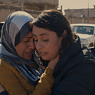 Doc Edge Festival 2022. Image from the film 'Angels of Sinjar' in which two women are embracing and consoling each other.