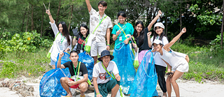 A group of students collecting rubbish on the beach