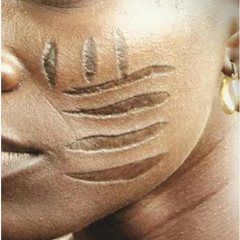  I am the tribal mark of the Yoruba people inscribed onto children's faces and bodies for identification purposes. I was a thing of pride, especially serving as a beautifying object on women’s faces, when they came of marriageable age. I now belong to the past. I may not have outlived my purpose but I have now been criminalised and prohibited.