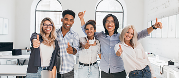 Diverse group of adult students giving thumbs up