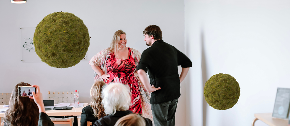 Two people facing each other dancing in front of the audience