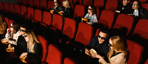 Audience Sitting on Chairs in a Cinema