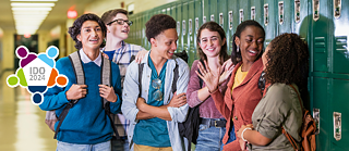 Teenagers standing in front of school lockers