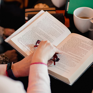 Person holding an open book during an online German book club for language learners with Goethe-Institut USA