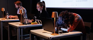 Christophe Fricker, Janiça Hackenbuchner and Ayça Türkoğlu on the stage during the (Wo)man versus machine translation slam