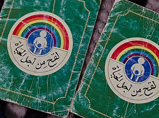  جوازا سفر التوأم،  وثيقتان رسميتان باللغة العربية  عليهما رمز قوس قزح.