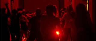 Menschen die in roten Licht tanzen 