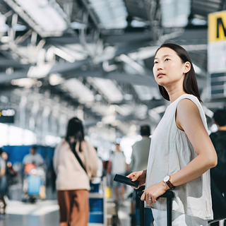 A lady is standing at the airport