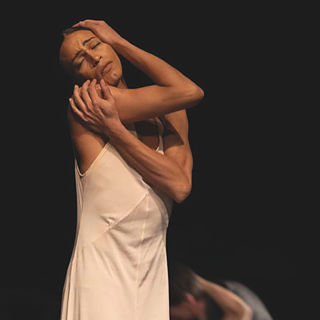 A woman dancing with her eyes closed. 'Cafe Müller' by Pina Bausch. Image: Oliver Look, courtesy of Berliner Festspiele