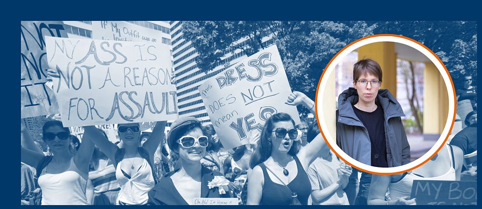 A blue-tinted photo shows protesters at a “Slut Walk” in Philadelphia in August 2011. Most appear to be female-presenting and are holding signs, one of which reads: “My ass is not a reason for assault.”