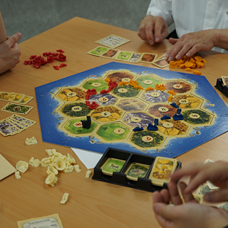 People playing Catan