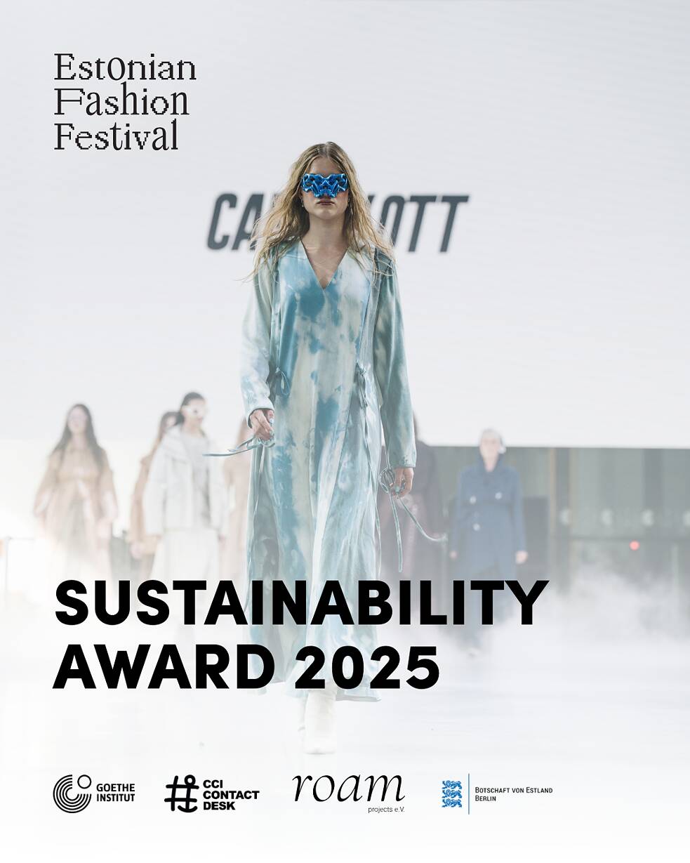 A model walks down a fashion runway at the Estonian Fashion Festival. Behind the model, a large screen displays the text SUSTAINABILITY AWARD 2025 along with logos for Goethe-Institut CCI Contact Desk roam projects eV and the Embassy of Estonia in Berlin
