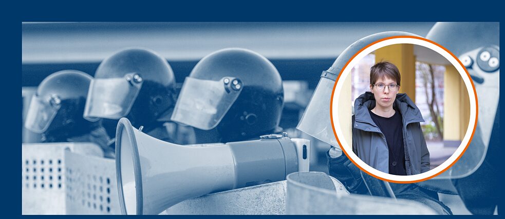 A blue-tinted photo shows police officers wearing hard hats, one of them holding a megaphone. On the right is the author of the language column Bettina Wilpert