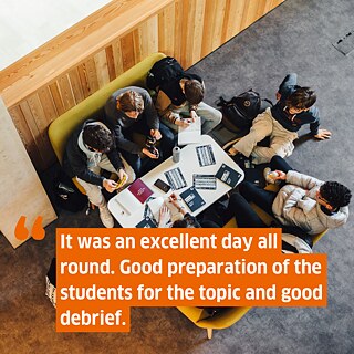 Photo of a group of students sitting around a table, point of view from above. Superimposed the text: It was an excellent day all round. Good preparation of the students for the topic and good debrief.